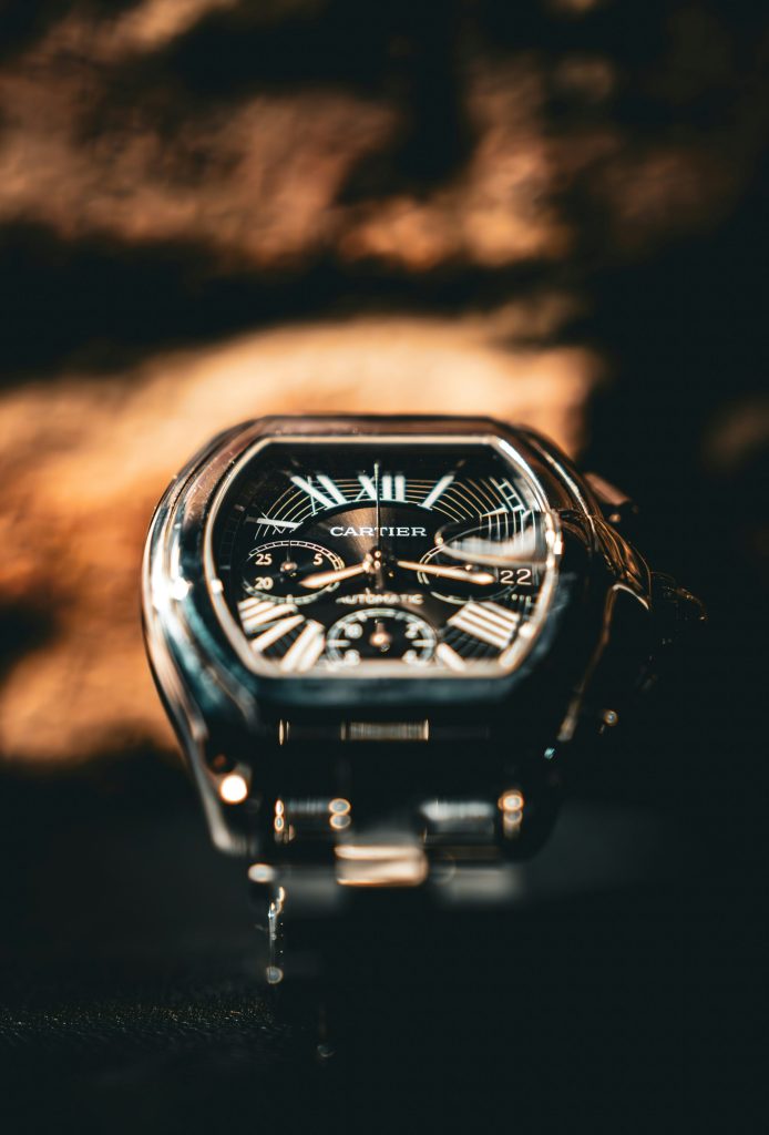 A cartier watch is displayed in close-up.